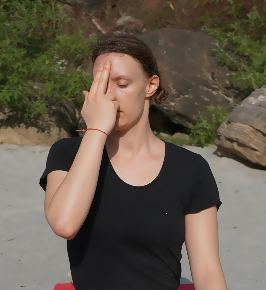 Student practising Anulom Vilom alternate nostril breathing in a yoga hall in Rishikesh