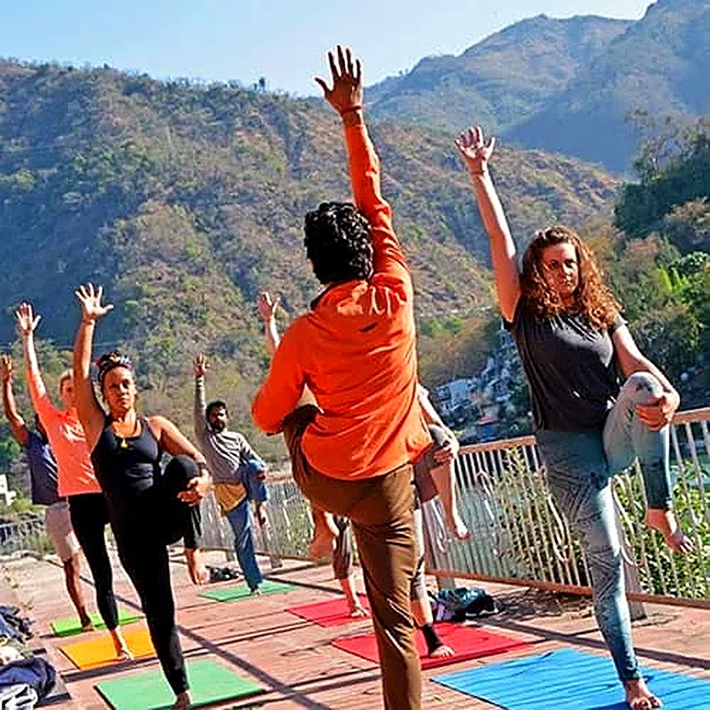 100-hour teacher trainees practicing a group asana pose in Rishikesh