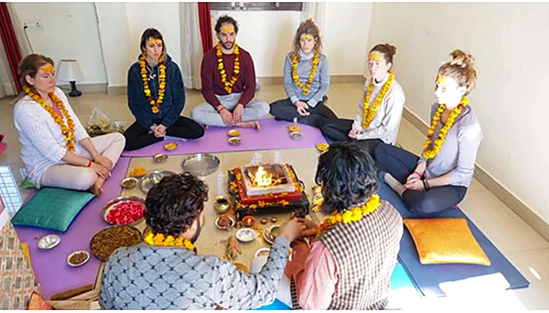 Students chanting mantras during a havan ceremony at the ashram
