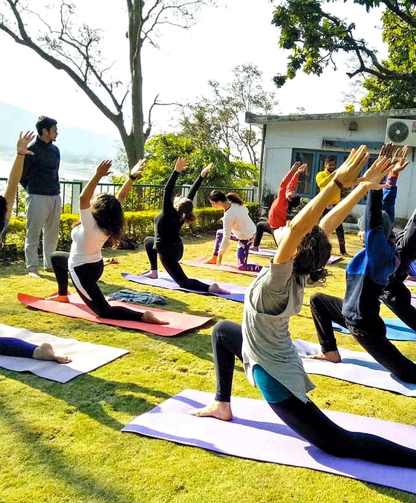 Anatomy and physiology study during a low lunge pose class in Rishikesh