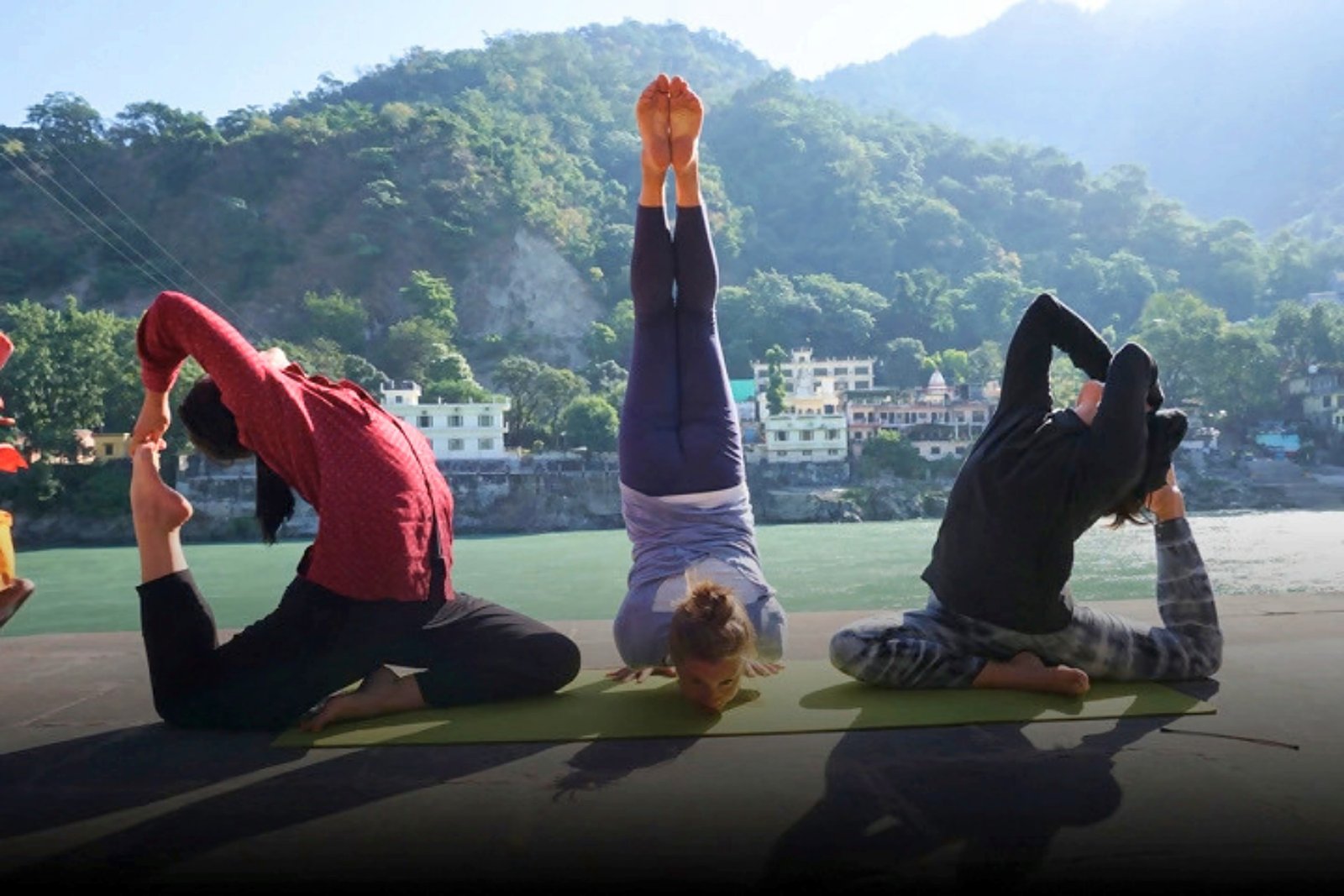 Rooftop yoga poses with a view of the Ganga
