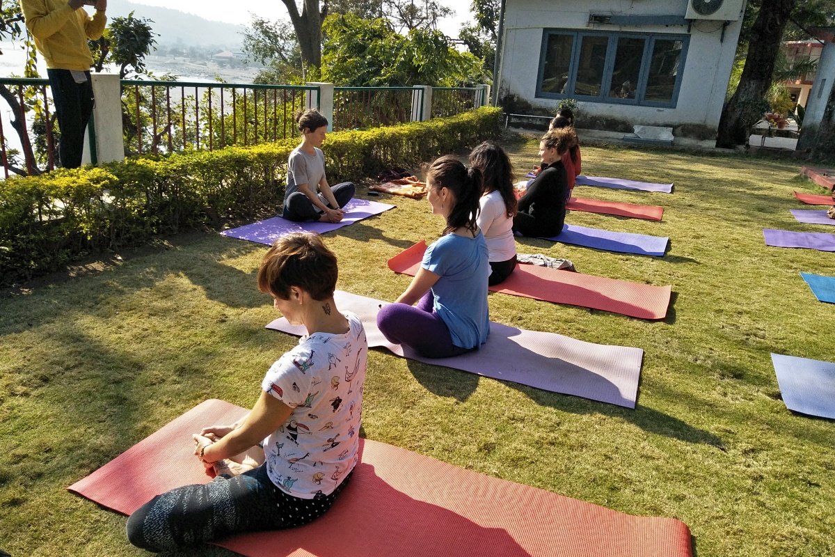 Seated pranayama yoga class in the garden