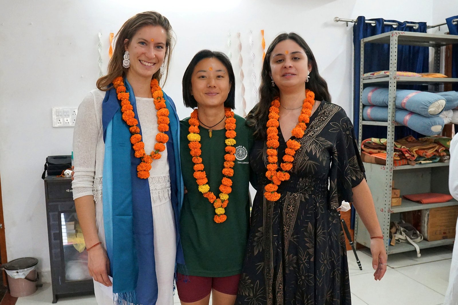 Yoga TTC graduates wearing marigold garlands