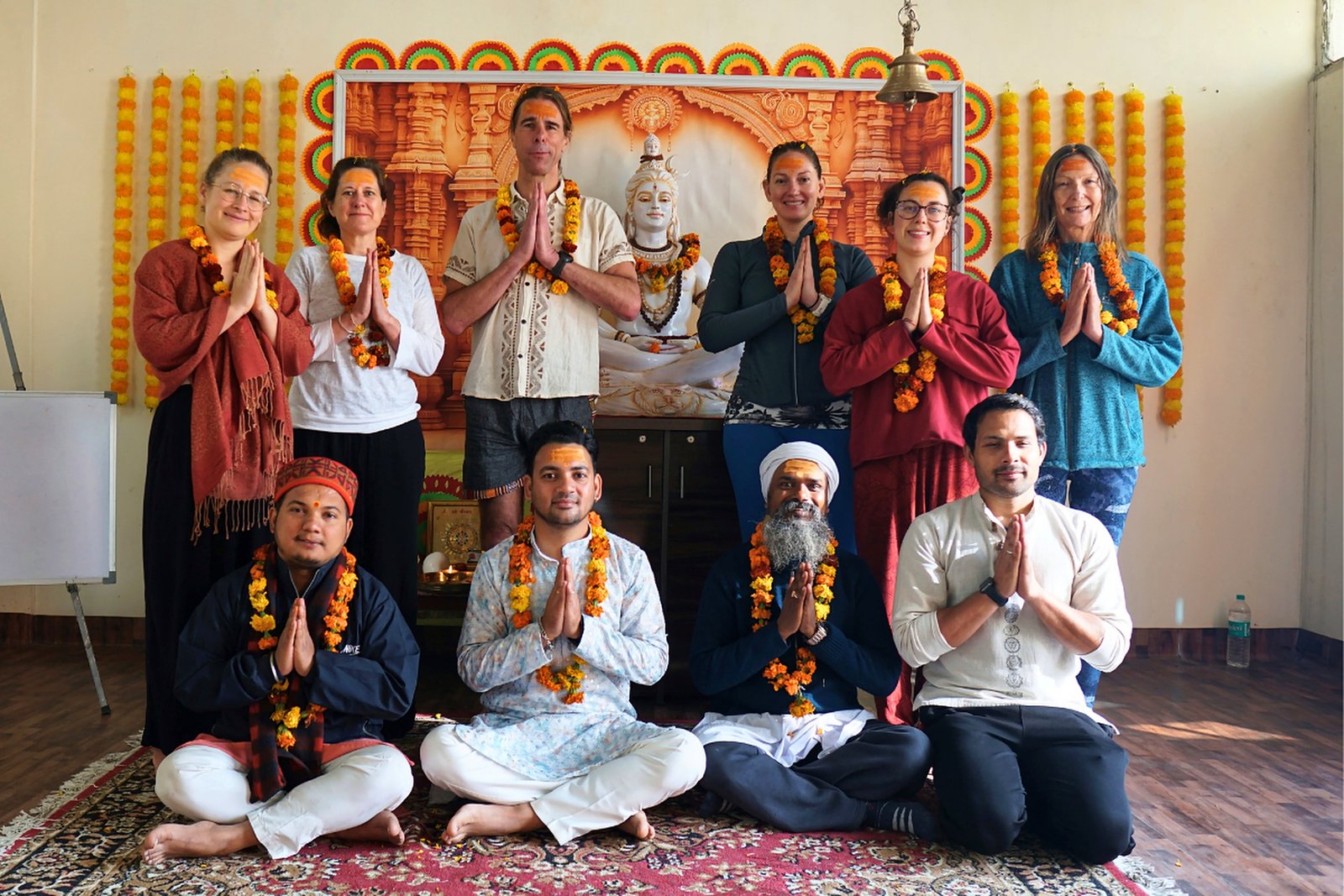 Yoga TTC graduates gathered at the Shiva altar in the ashram
